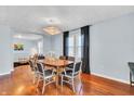Bright dining room with hardwood floors, modern chandelier, and large windows at 1655 Cornell Ave, Indianapolis, IN 46202