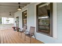 Relaxing porch with two chairs and flowers, perfect for enjoying the outdoors at 1665 N College Ave, Indianapolis, IN 46202