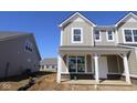 Attractive two-story home with covered porch and visible brick foundation at 16829 Silo Meadows Dr, Noblesville, IN 46060
