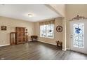 Inviting living room with wood-look floors, a large window for natural light, and a decorative glass front door at 2282 Creekland Dr, Columbus, IN 47201
