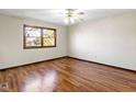 This bedroom has hardwood floors, a ceiling fan, and a window at 321 Pleasantview Dr, Greenwood, IN 46142