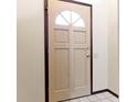 The front door has a half-moon window and dark trim at 321 Pleasantview Dr, Greenwood, IN 46142