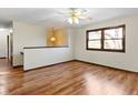 Spacious living room with beautiful hardwood floors, ceiling fan, and natural light at 321 Pleasantview Dr, Greenwood, IN 46142