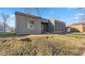 Single-story home with gray siding and a lawn, situated on a bright, sunny day at 3661 Yellow Poplar Ct, Indianapolis, IN 46222