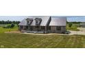 Aerial view of a brick home with metal roof, spacious yard, and surrounding greenery at 3777 S 300 E, Anderson, IN 46017