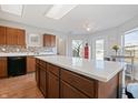 Spacious kitchen featuring an island with white countertop, wood cabinets, and stainless steel appliances at 380 Winterset Way, Greenwood, IN 46143