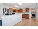 Bright kitchen with wood cabinets, stainless steel appliances, and a view of the laundry room at 380 Winterset Way, Greenwood, IN 46143