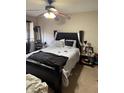 Bedroom with black bed frame, ceiling fan, and a window with curtains at 4291 Village Parkway W Cir # 8, Indianapolis, IN 46254