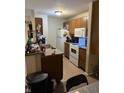 Functional kitchen with wooden cabinets, a white refrigerator, and laminate countertops at 4291 Village Parkway W Cir # 8, Indianapolis, IN 46254