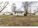 Charming single-story home with a covered porch and a detached garage nestled in a spacious yard at 4355 W 450 S, Columbus, IN 47201