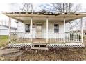 Quaint covered front porch with classic white railing and details enhancing the home's curb appeal at 4355 W 450 S, Columbus, IN 47201