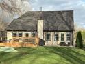 Backyard view featuring a spacious wooden deck, grill, outdoor seating, and a lush lawn at 5018 Melbourne Rd, Indianapolis, IN 46228