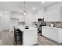 Modern kitchen featuring white cabinetry, an island with seating, and stainless appliances at 5777 Cr W 750 N, McCordsville, IN 46055