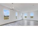 Sun-filled living room with expansive windows, recessed lighting, and sleek, modern flooring at 5785 Cr W 750 N, McCordsville, IN 46055