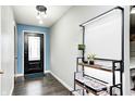 Bright entryway boasting dark hardwood flooring and a modern light fixture at 5984 Williams Dr, Plainfield, IN 46168