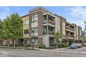 Exterior view of a modern condo with multiple balconies, brick accents, and landscaped surroundings at 622 E 10Th St # 206, Indianapolis, IN 46202