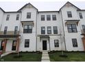 Stylish townhome displays modern architecture, a well-maintained lawn, and inviting entryways at 7085 Pate Hollow Dr, Brownsburg, IN 46112