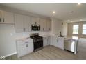 Bright kitchen showcases stainless appliances, sleek countertops, and ample gray cabinet storage at 7085 Pate Hollow Dr, Brownsburg, IN 46112