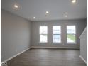 Open living room features recessed lighting, hardwood floors, and large windows for natural light at 7085 Pate Hollow Dr, Brownsburg, IN 46112