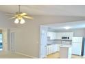 Open concept kitchen with white cabinetry, modern appliances, and a ceiling fan at 788 Tulip Ln, Greenwood, IN 46143