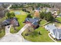 Expansive aerial view of home with tennis court, manicured lawn, and lush landscaping at 8078 Sunfish Ct, Indianapolis, IN 46236