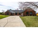 Attractive single story brick home with long driveway, well maintained lawn and mature trees at 8078 Sunfish Ct, Indianapolis, IN 46236