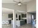 Modern kitchen with stainless steel appliances, gray cabinets, and a white island at 817 Capricorn Dr, Franklin, IN 46131