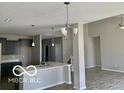 Modern kitchen and open floor plan with stainless steel appliances and a large island at 817 Capricorn Dr, Franklin, IN 46131