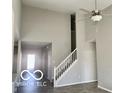 Bright living room featuring a high ceiling, a ceiling fan and a staircase at 817 Capricorn Dr, Franklin, IN 46131