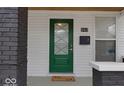 Up-close view of the home's elegant green front door with decorative glass and modern hardware at 843 N Oxford St, Indianapolis, IN 46201