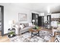 Open-concept living room featuring modern decor and seamless flow into the kitchen at 928 E Pleasant Run Parkway North Dr, Indianapolis, IN 46203