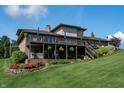 Expansive backyard with multi-tiered deck, hot tub, and lush landscaping on a sunny day at 9398 W Mirror Rd, Columbus, IN 47201