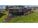 Spacious backyard with a multi-level deck, hot tub, and lush landscaping at 9398 W Mirror Rd, Columbus, IN 47201
