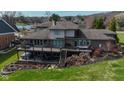 Aerial view of the backyard with a multi-level deck and well-maintained lawn at 9398 W Mirror Rd, Columbus, IN 47201