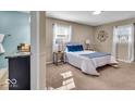 Comfortable bedroom featuring plush carpeting, a full-size bed and two windows at 9715 Mallery Dr, Noblesville, IN 46060