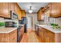 Well-lit kitchen featuring wood cabinets, modern appliances, and a window over the kitchen sink at 9715 Mallery Dr, Noblesville, IN 46060