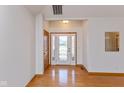 Bright foyer with hardwood floors, decorative glass front door, and fresh neutral paint at 1114 Woodridge, Brownsburg, IN 46112