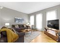 Cozy living room featuring hardwood floors, ample natural light, and comfortable furniture at 1240 Wayne St, Noblesville, IN 46060