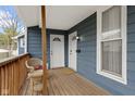 Inviting front porch with a charming wicker chair and view of the entryway at 1240 Wayne St, Noblesville, IN 46060