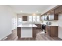 Bright, modern kitchen with stainless steel appliances, center island, and sleek countertops at 14562 Hanford Ln, Carmel, IN 46074