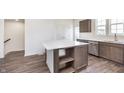 Kitchen island with stainless steel sink, seating area, and storage underneath at 14562 Hanford Ln, Carmel, IN 46074