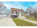 Exterior showcasing gray siding, landscaping, and driveway leading to detached garage at 15 N Fleming St, Indianapolis, IN 46222