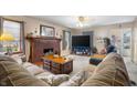 Inviting living room with a brick fireplace, a plush sofa, and a wooden coffee table at 15 N Fleming St, Indianapolis, IN 46222
