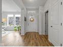 Bright foyer with wood floors, white trim and walls, and a front door with glass and a wreath at 17301 Dallington St, Westfield, IN 46074