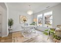 Stylish home office featuring a modern chandelier, large windows, and light wood-look floors at 17301 Dallington St, Westfield, IN 46074
