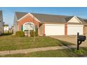 Attractive home featuring a brick facade, attached garage, and lush green lawn at 198 Rapid Rill Ln, Brownsburg, IN 46112