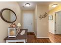 Inviting entryway featuring warm lighting, a decorative mirror, and hardwood floors at 198 Rapid Rill Ln, Brownsburg, IN 46112
