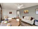 Cozy living space with neutral tones, modern ceiling fan, and wood-look floors at 207 E Ohio St, Mooresville, IN 46158