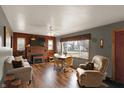 Inviting living room features wood paneling, brick fireplace, wood floors and an abundance of natural light at 207 E Ohio St, Mooresville, IN 46158