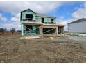 Two story home under construction showing framing and weather barrier, with a clear blue sky at 2242 Oakmont Dr, Plainfield, IN 46168